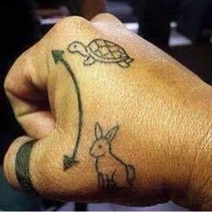 Hare-And-Tortoise-Small-Tattoo-On-Hand.jpg