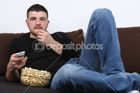 depositphotos_41606545-Young-man-watching-tv-and.jpg